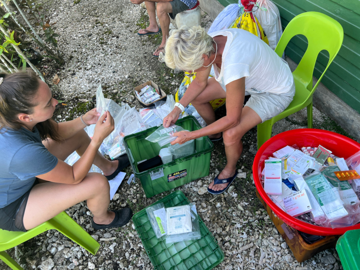 Monika and Jessica meticulously check the pharmacy inventory. A good portion will be given to the Palmalmal health center.